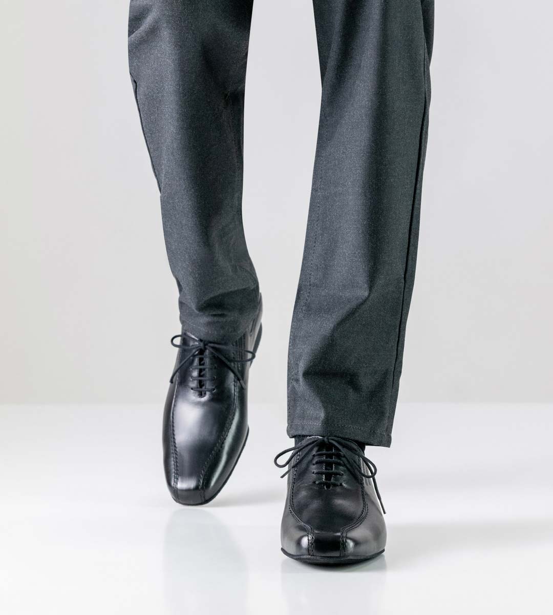 Pesaro black men's dance shoe by Werner Kern from the front in combination with trousers in grey
