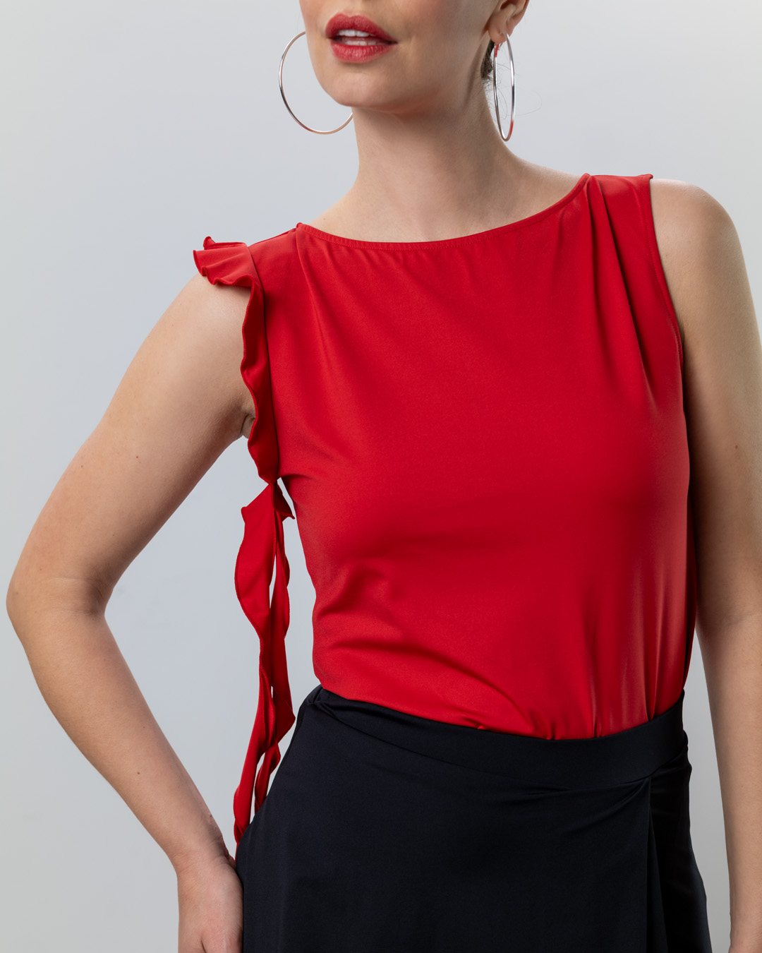 Lior dance top in red by Werner Kern with ruffled trim on the right armhole