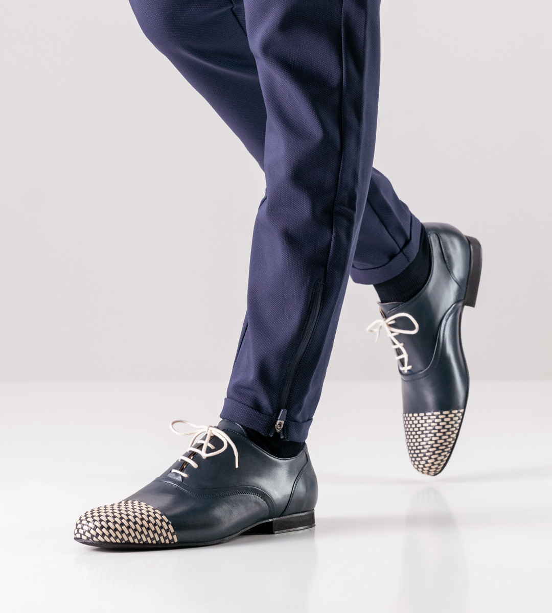 Blue trousers in combination with blue-beige men's dance shoes by Nueva Epoca