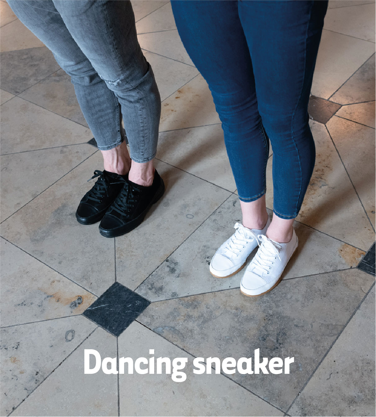 Two dancers wear dance sneakers and stand next to each other. 