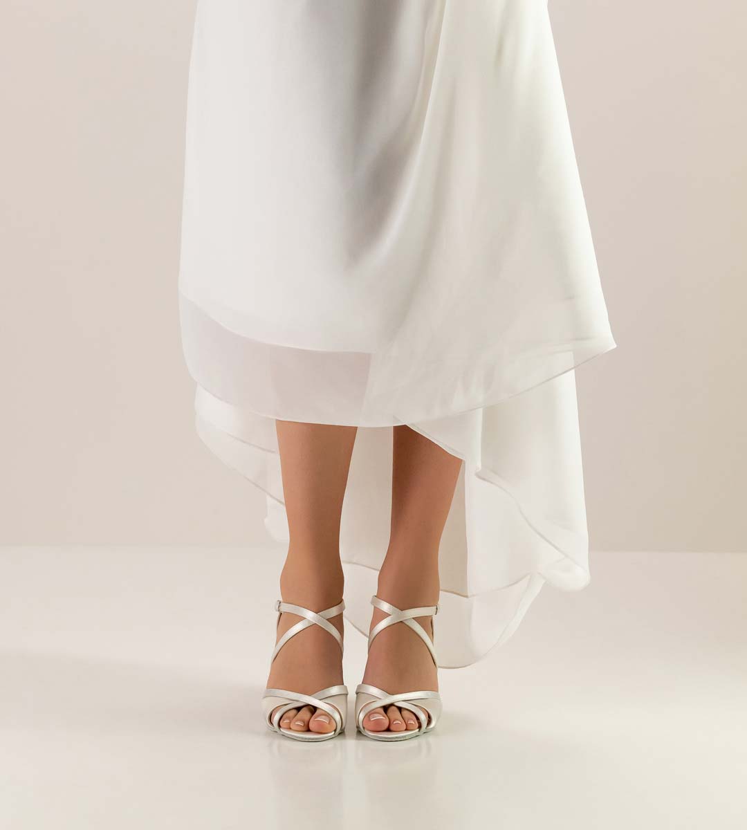 July white wedding dress in combination with white bridal shoe by Werner Kern