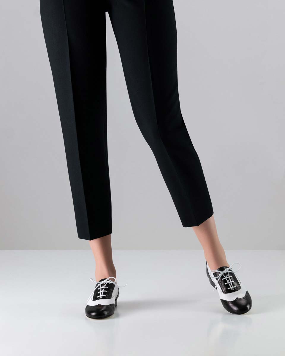 Ladies' dance shoe for swing in black and white in combination with black trousers