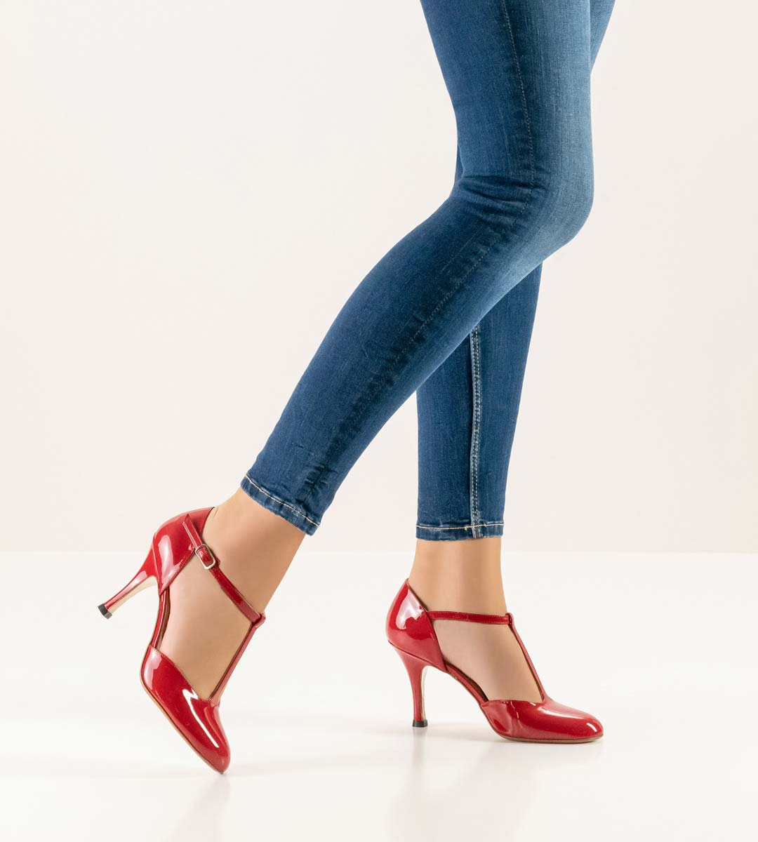 Roslyn T-bar ladies dance shoe by Nueva Epoca in red in combination with blue jeans