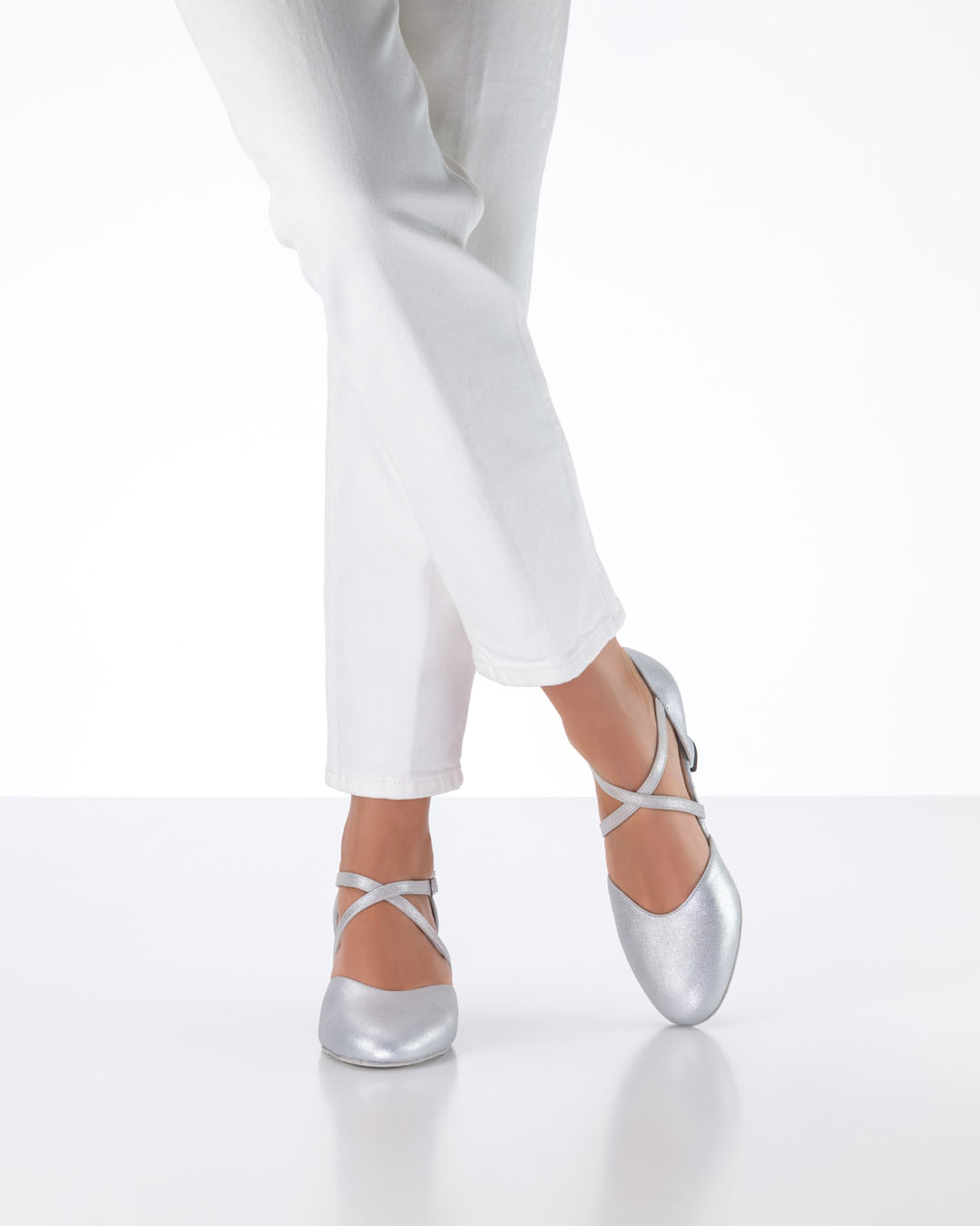 Model wearing white jeans and silver Felie dance shoes by Werner Kern
