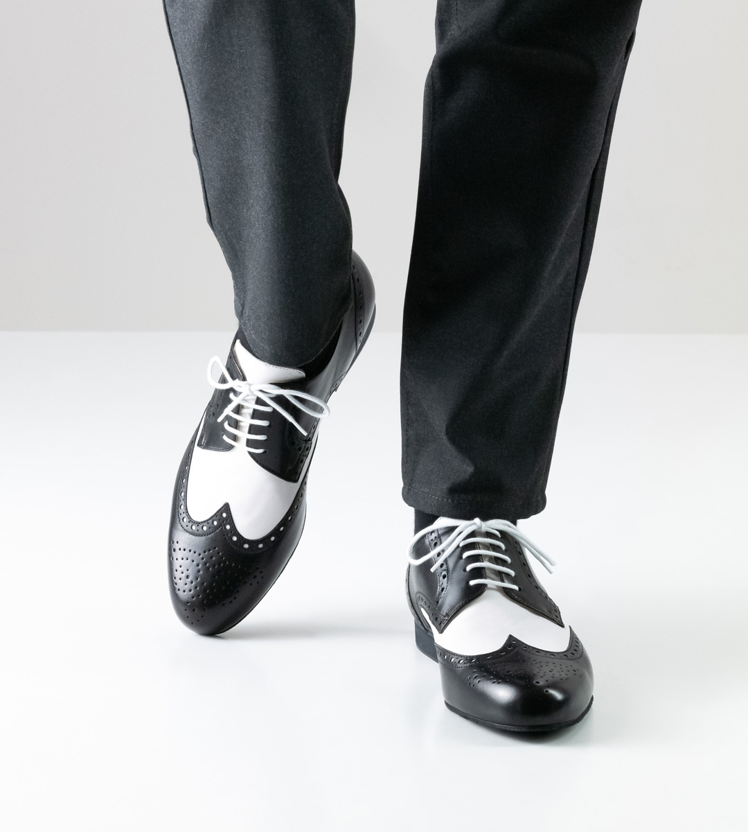 black and white men's dance shoe for tango by Werner Kern in combination with grey trousers