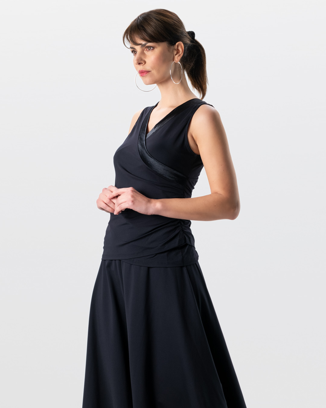 Slim-fit dance top with a wrap-around look, made from black stretch fabric with a V-neckline by Werner Kern.