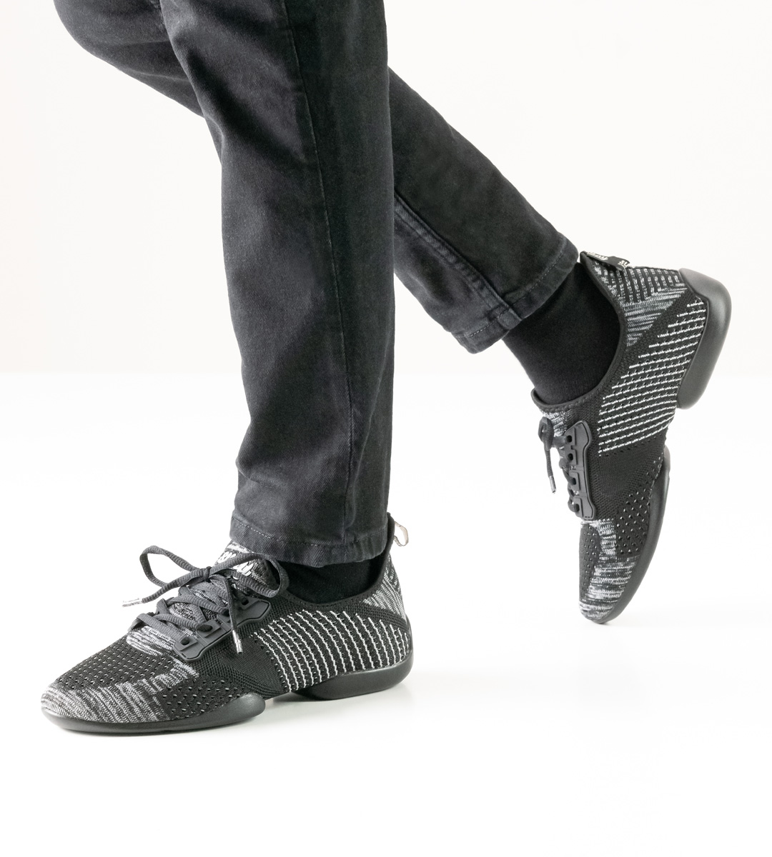 Black and grey men's dance sneaker by Suny in combination with black trousers