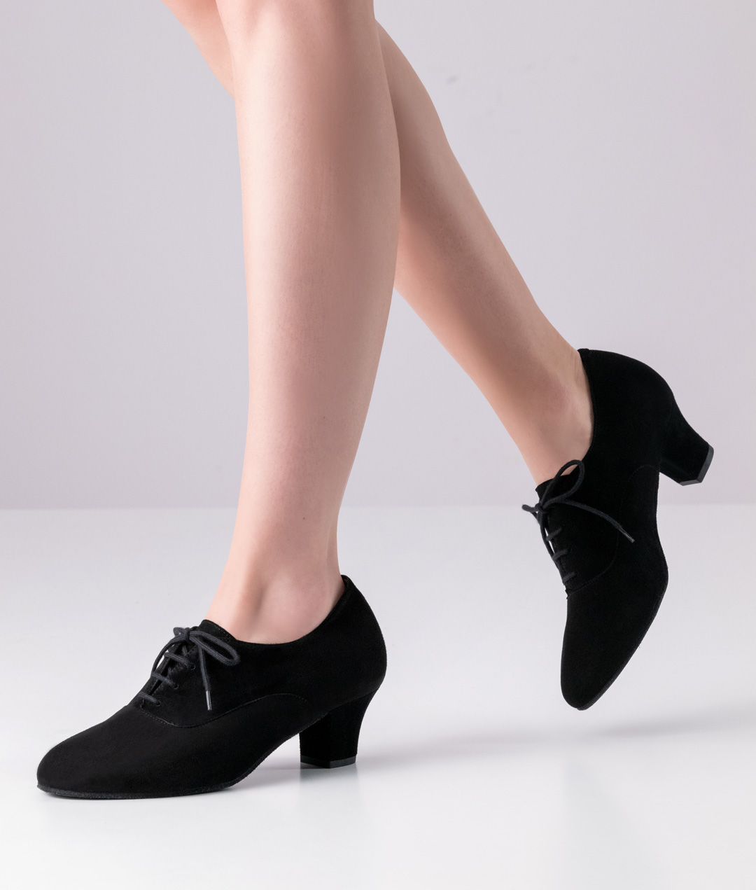 Closed-toe dance shoe with removable footbed made from soft and supple suede, laces and a small heel.