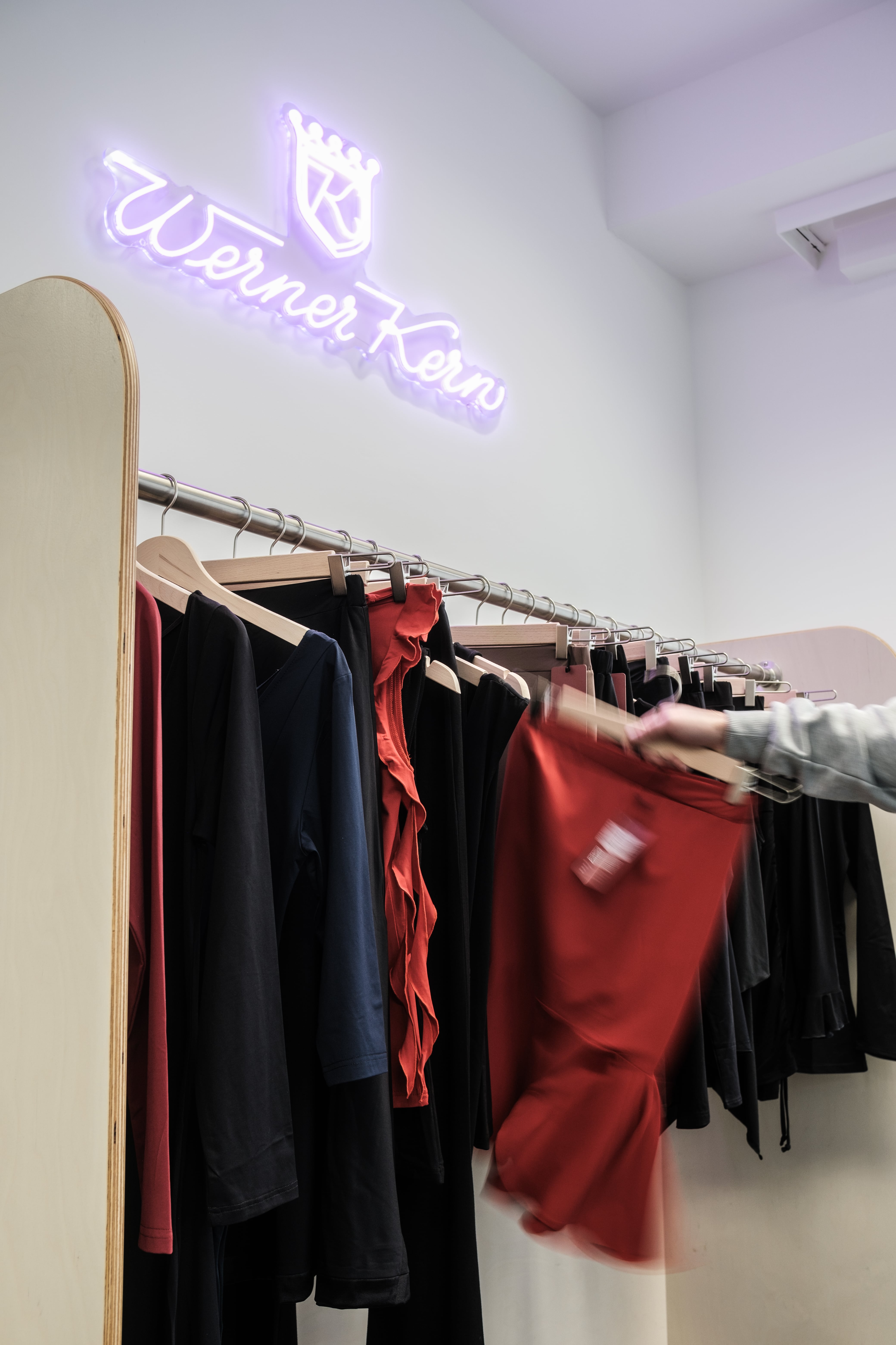 Changing area for dancewear with an illuminated logo that says "Werner Kern."