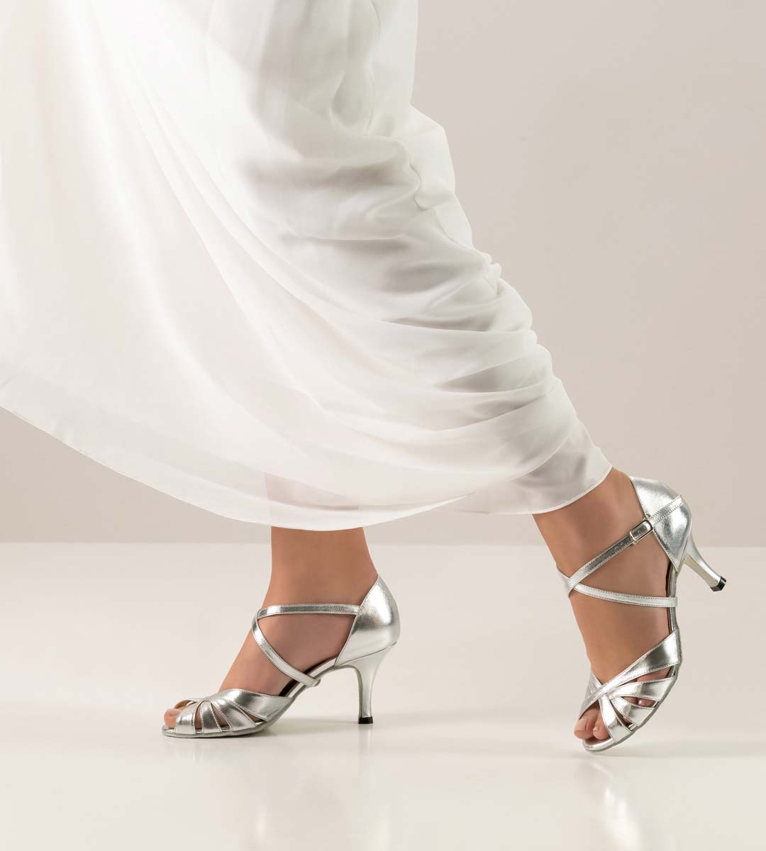 White wedding dress in combination with silver coloured bridal shoe