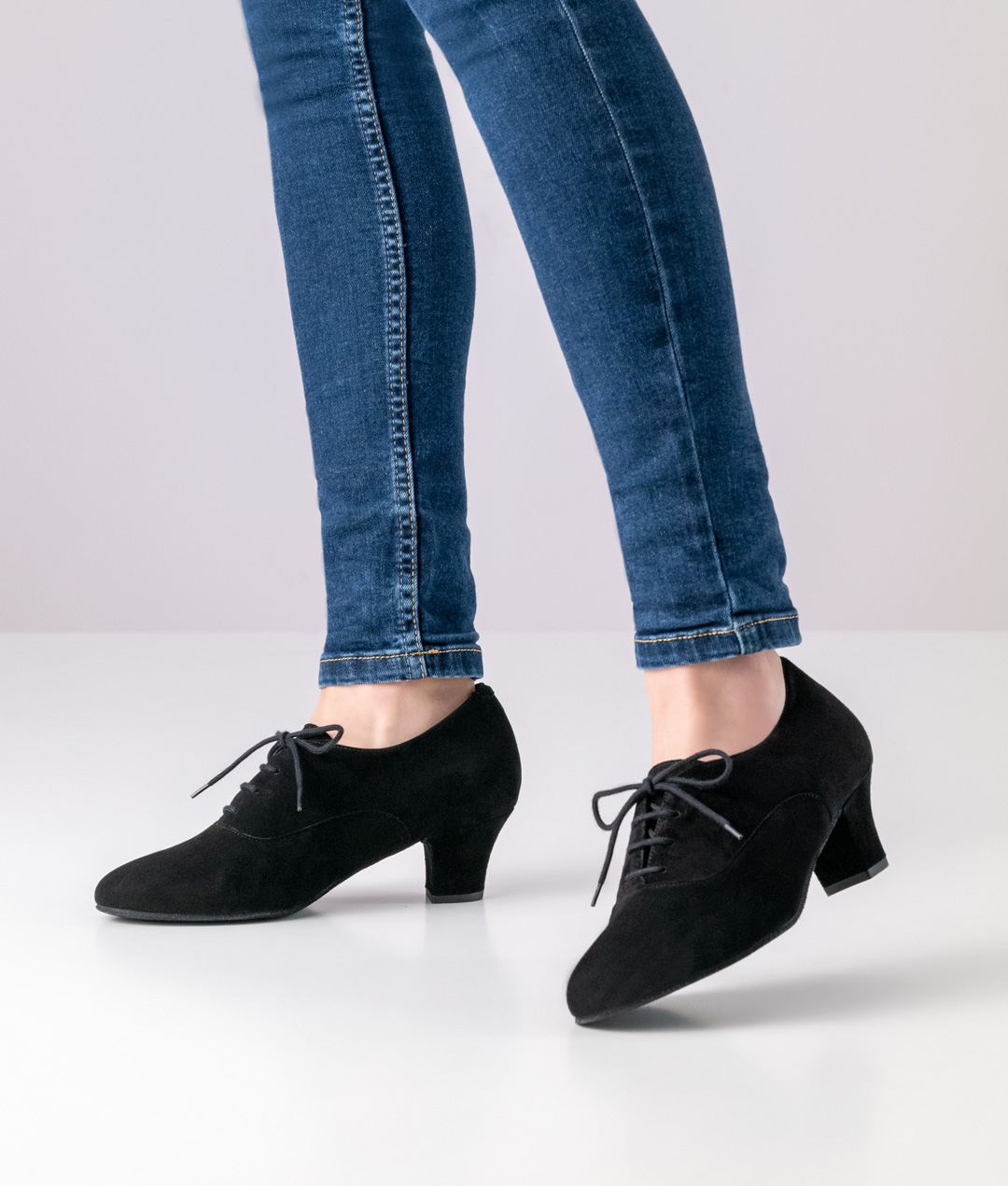 Black, closed ladies' dance shoe made of suede leather with laces and a small heel by Werner Kern.