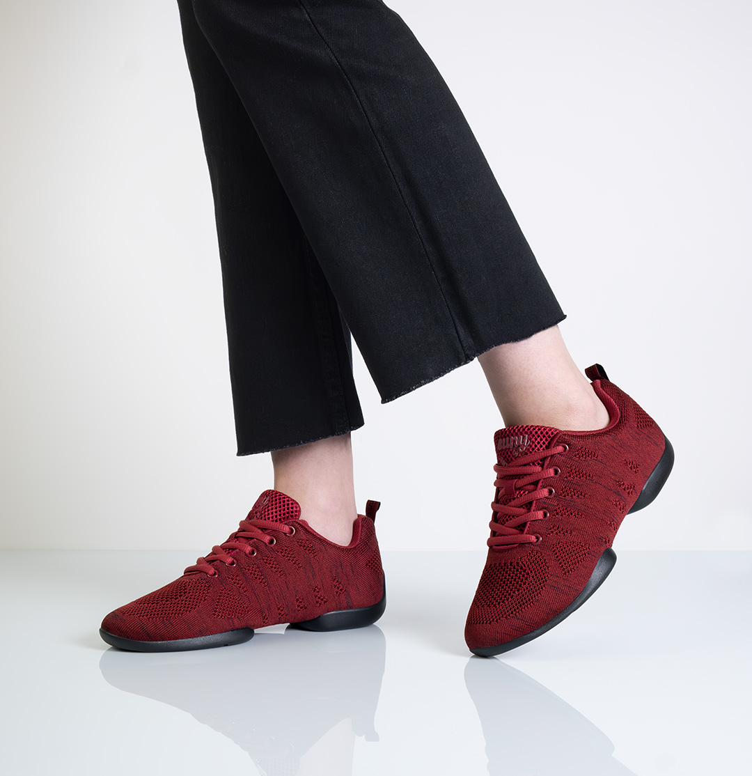 Side view of Suny dance sneakers in red for women
