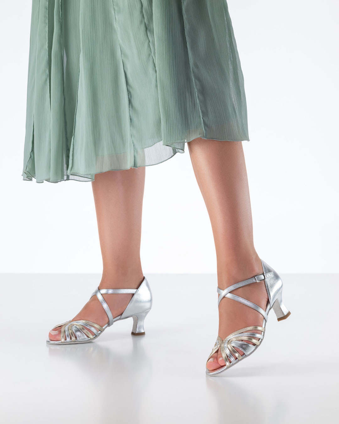 Ginger silver dance sandals worn with a mint-coloured, loose-fitting skirt