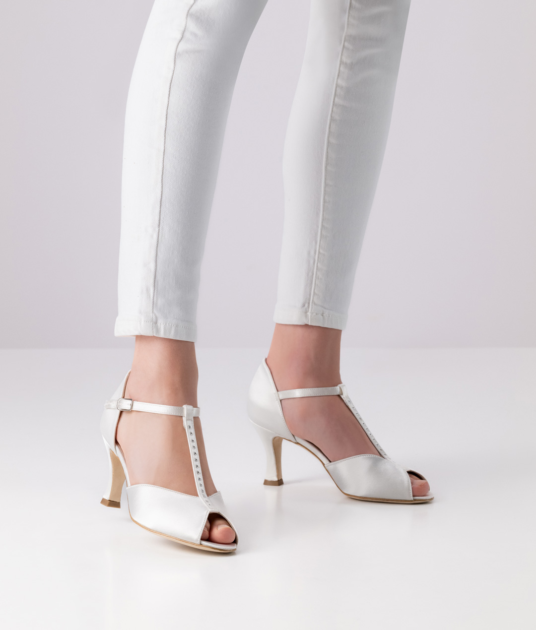 Peep toe dance shoe Mona with leather sole, T-strap, 6 cm heel and rhinestones completely in white satin by Werner Kern.