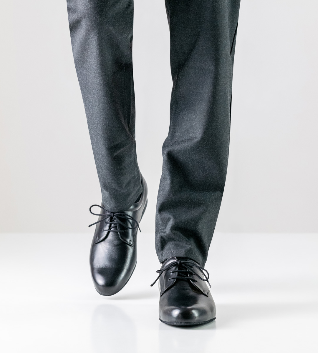 Grey trousers in combination with men's dance shoe in black leather