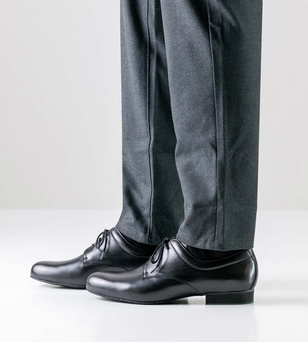 Arezzo Side view of Werner Kern men's dance shoe with micro heel in combination with grey trousers