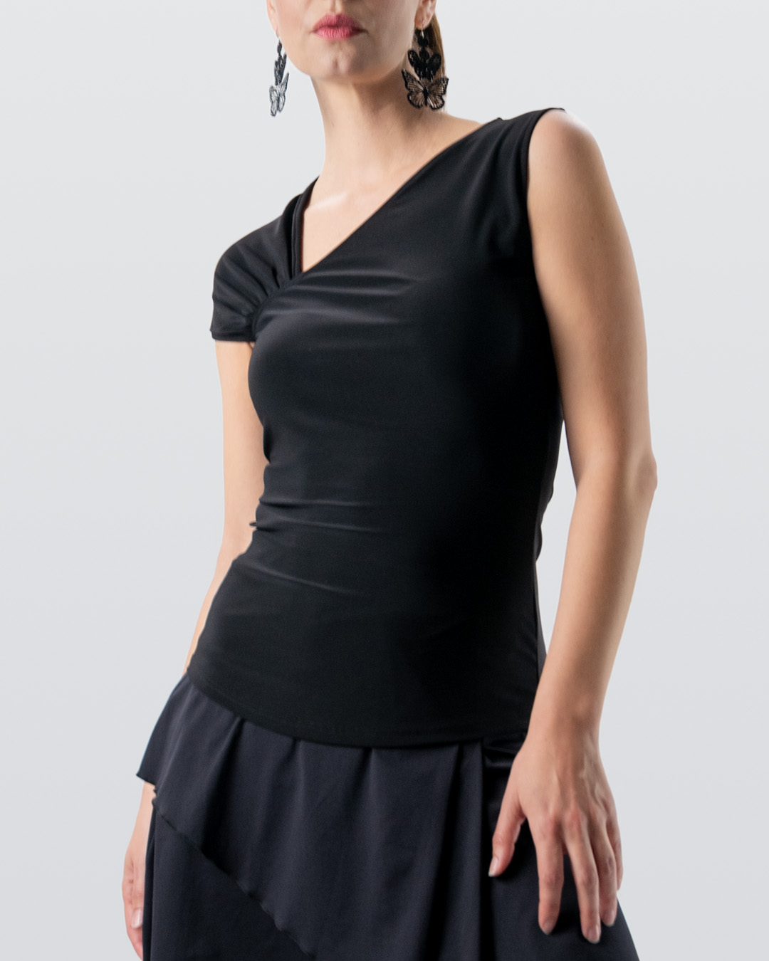 Slim-fit dance top in black with asymmetrical V-neck and different sleeve designs by Werner Kern