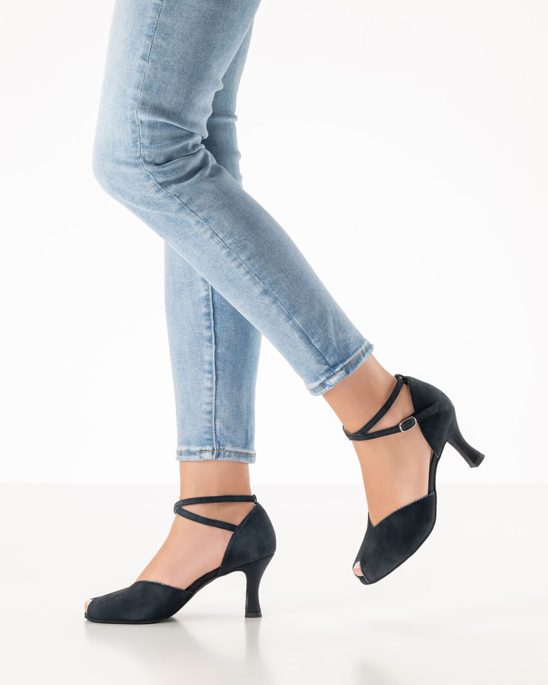 Side view of a model wearing light-coloured jeans and black dance shoes with a 6.5 heel and a small peep-toe opening