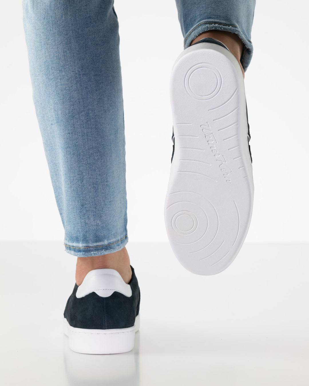 View of the sole of a pair of white dance trainers from below, by Werner Kern