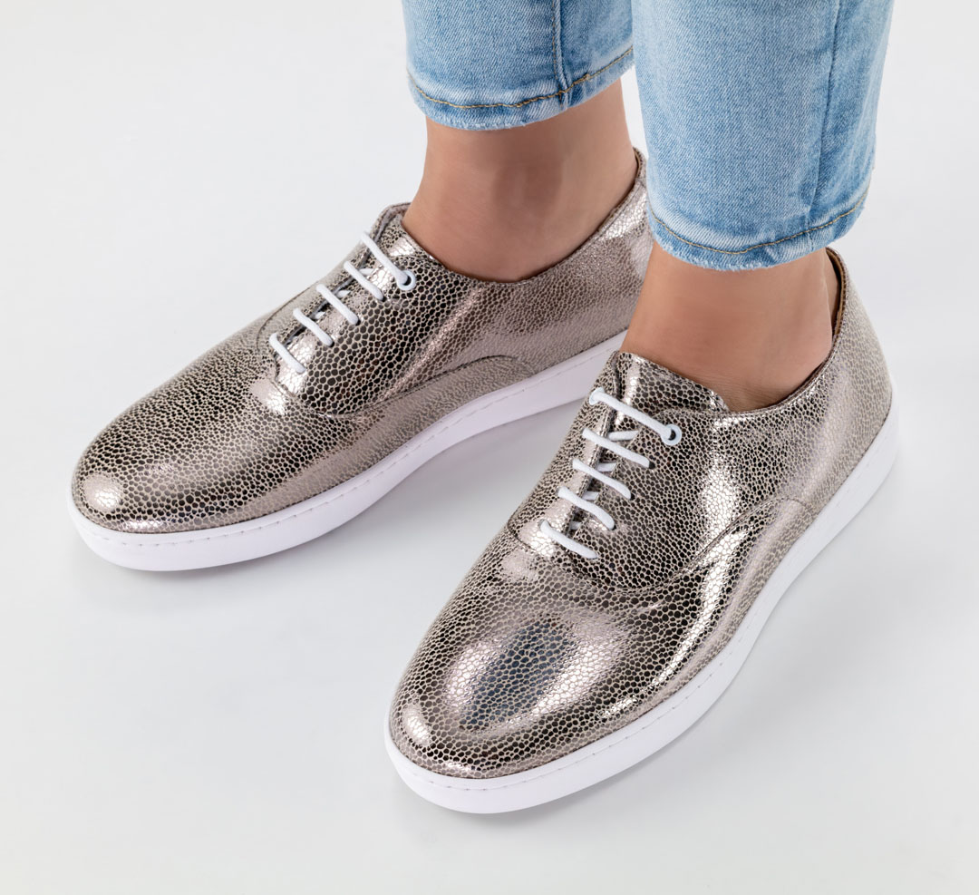 Flat lace-up dance shoes for women in a shiny platinum-coloured material by Werner Kern, with a white trainers’ sole