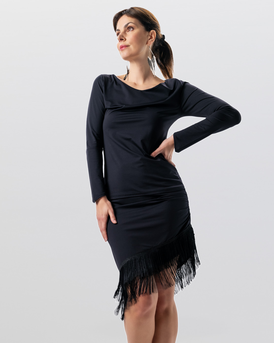 Model wears black dance skirt Oya with slanted hem and fringes by Werner Kern